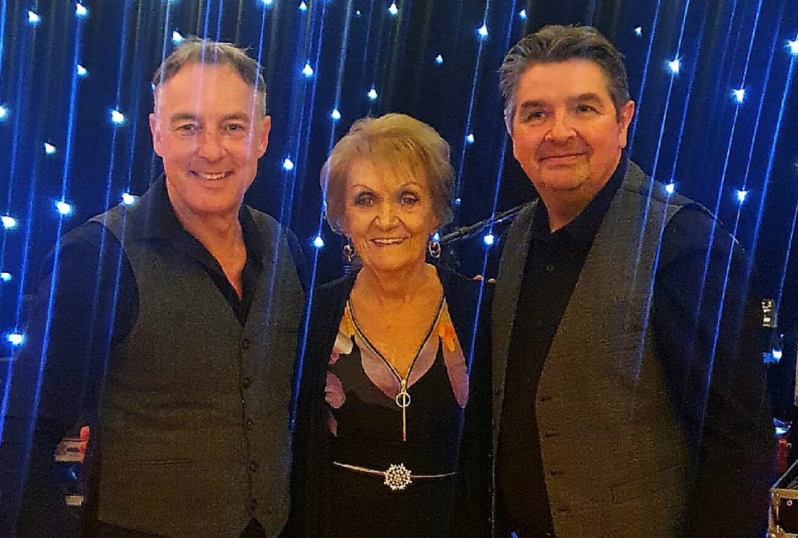 Pepperpot's Darin Bell and Brian Lyons with Philomena Begley in 2023.
