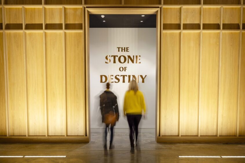Two visitors at entrance to Stone of Destiny Experience in Perth Museum