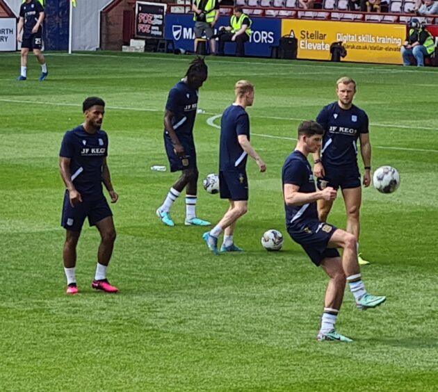 Dutch defender Robin Lathouwers warms up with Dundee subs at Hearts. Image: George Cran/DCT.