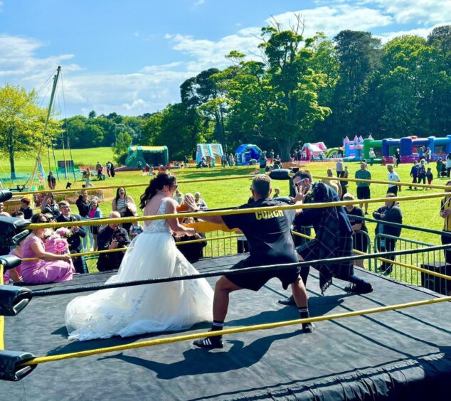 The couple inside the wrestling ring on their wedding day. 
