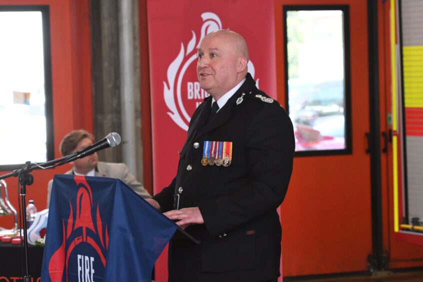 Scottish Fire and Rescue Service Chief Officer Ross Haggart speaking at a podium at the ceremony