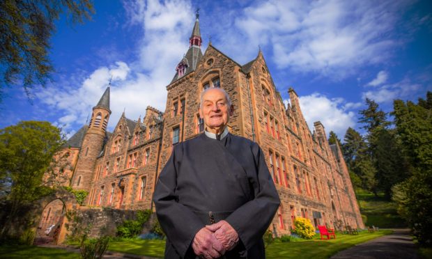 Father James MacManus, standing outside his church, has been casting out evil spirits and demons for more than 50 years. Image: Steve MacDougall.