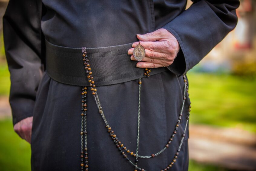 Detail on the waist area of Father James MacManus's outfit. 