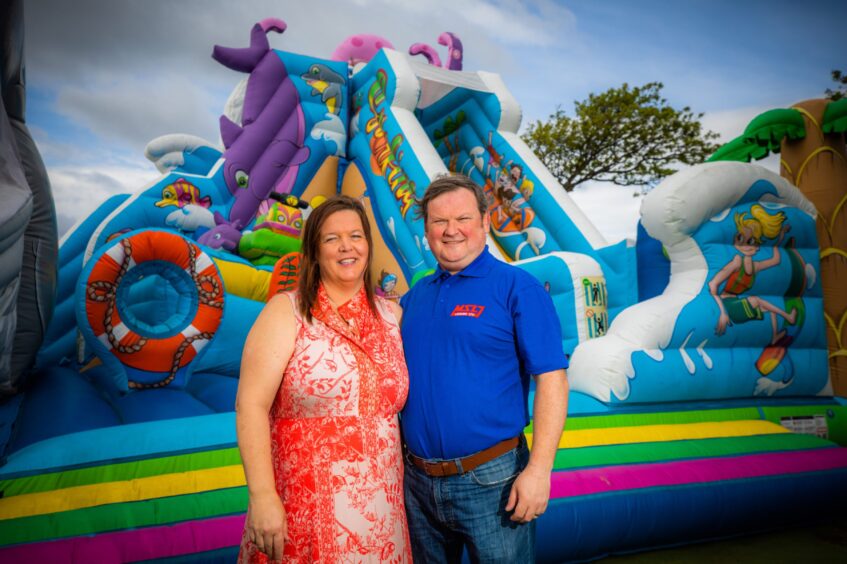 Ayshea and Michael Morris beside their bouncy castle on Leven Promenade