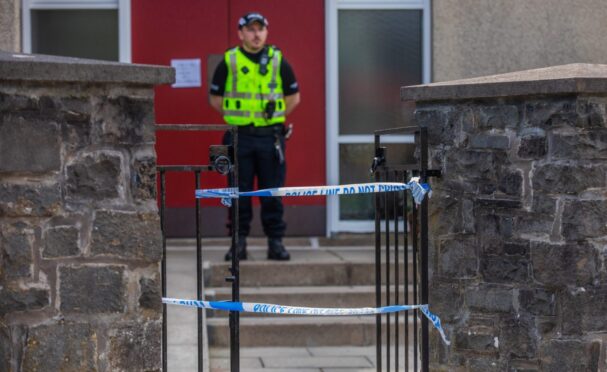 Police officer stands guard at St Mary Magdalene's Church in Perth following sudden death of man.
