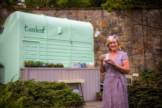 Sandra Bannister with here horsebox coffee shop in the own garden in the shadow of Culross Abbey.
