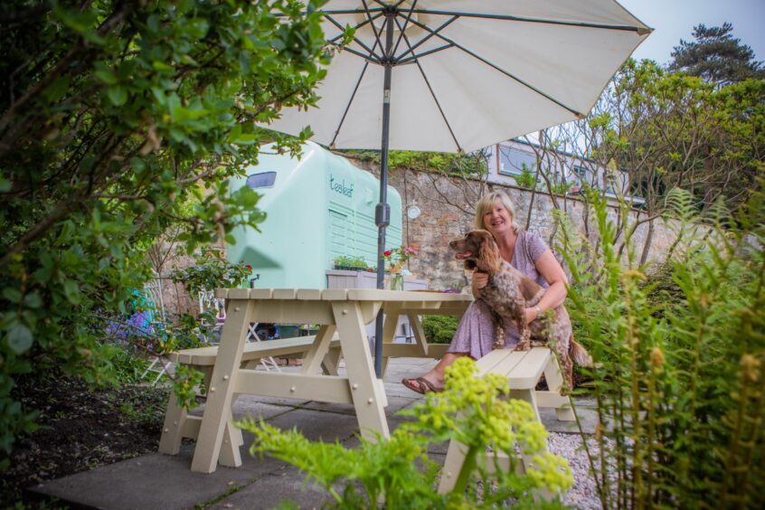 Sandra with her per dog Connie in the seating area of the pop-up cafe.