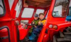Six-year-olds David Brown (left) and Joe Ritchie have a seat in one of the machines. Image: Steve MacDougall/DC Thomson