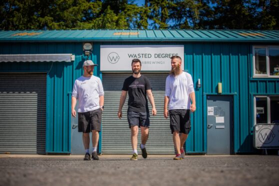 Three men outside Wasted Degrees brewery building in Blair Atholl