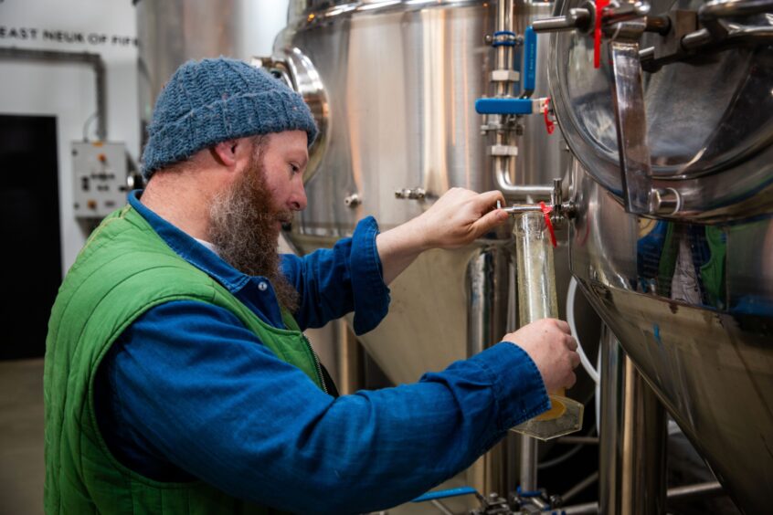Futtle co-owner Stephen Marshall checks fermentation at Futtle Brewery.