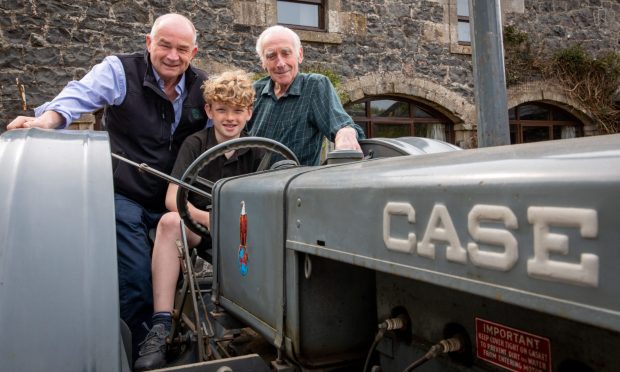 Three generations with Peter Small, dad Andrew Small (88) and Douglas Small (11) with the Case CC4 (1938) tractor that's been in the family since it was new. Image: Steve Brown/DC Thomson