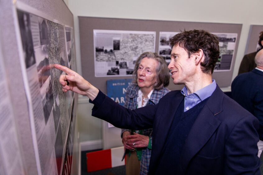 Ann McIntosh and Rory Stewart looking at map on Crieff Museum wall