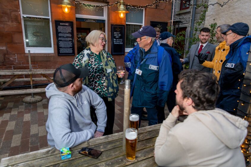 Street pastors chat with customers who are out socialising and have had a good day at Perth Festival. 