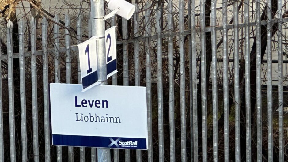The Leven station sign goes up, January 2024. 