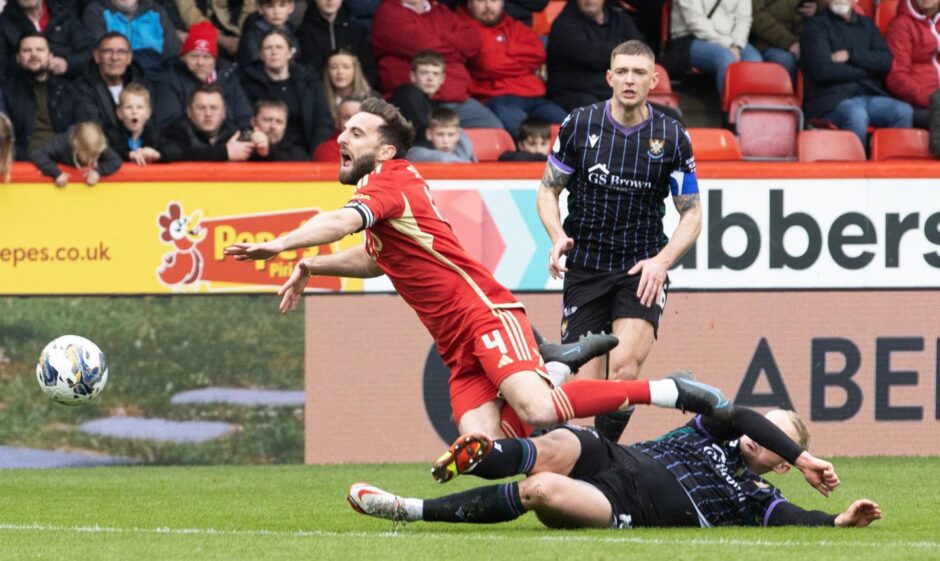 Cammy MacPherson challenges Graeme Shinnie. 