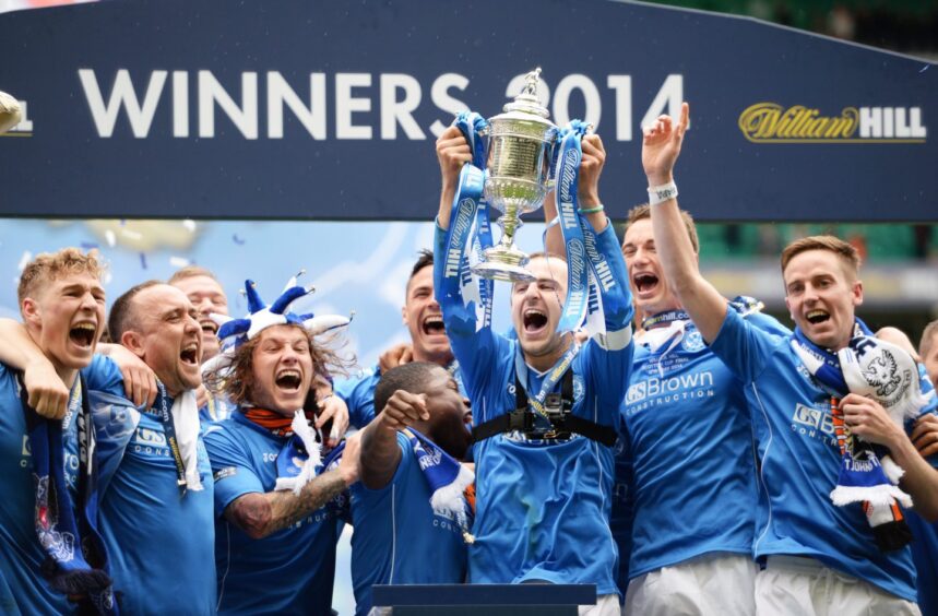 Captain Dave Mackay is the first man to get his hands on the Scottish Cup trophy. 