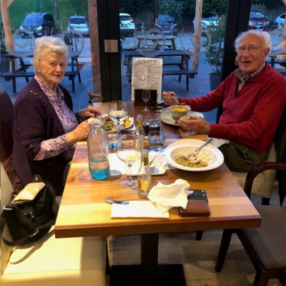 Shirley and John Walker seated at restaurant table