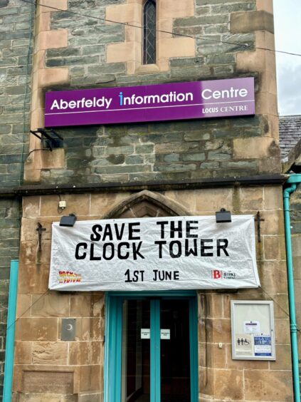 Aberfeldy Locus centre with banner strung across the front which reads 'Save the Clock Tower, 1st June'