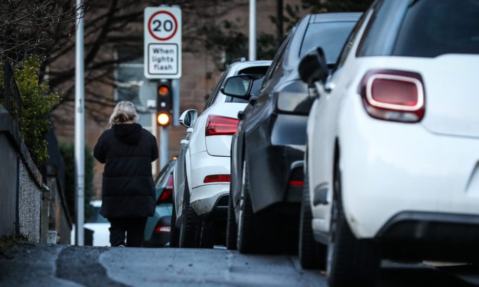 Dundee street with line if cars parked on pavement