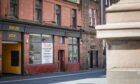 Empty building with To Let sign in window opposite Perth Museum