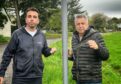 Mark Petrie and Angus Forbes standing next to pole where pop-up cop had been placed, holding broken chains