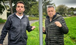 Mark Petrie and Angus Forbes standing next to pole where pop-up cop had been placed, holding broken chains
