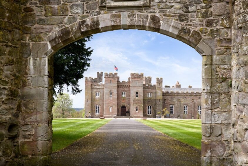 Stone archway with Scone Palace behind