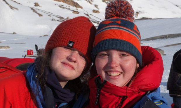 Ellis Milne and Kacey Coleman dressed in their hats and snow gear in Greenland during Braeview Polar Academy