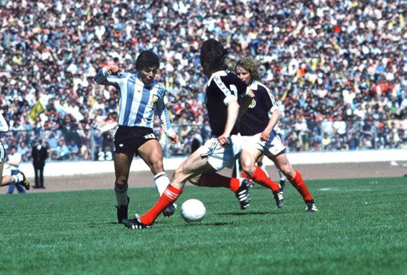 Maradona with the ball at his feet as he gives a man-of-the-match performance against Scotland.