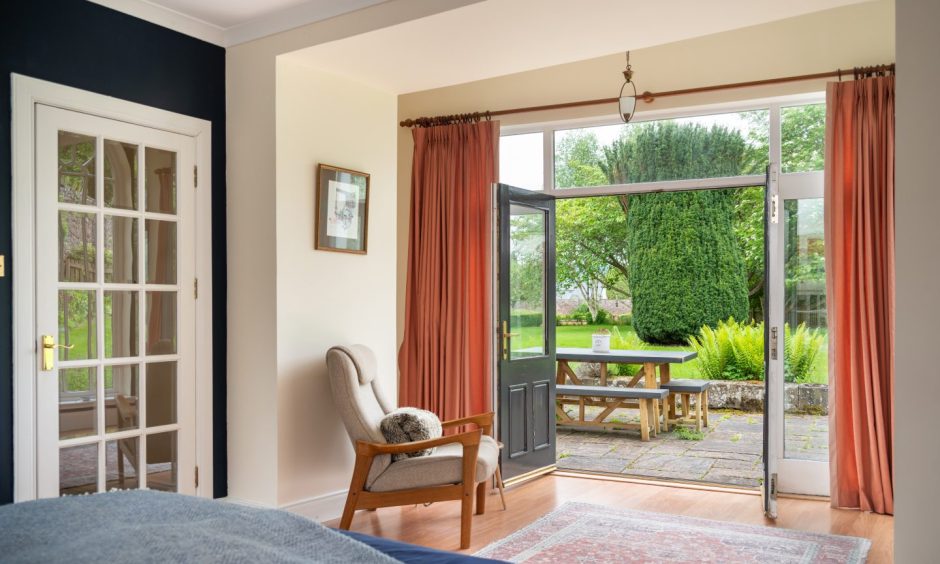 The bedroom has glazed doors to a sheltered patio.