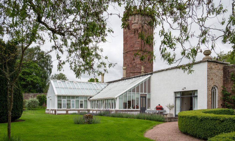 the property's tower and traditional glasshouse. 