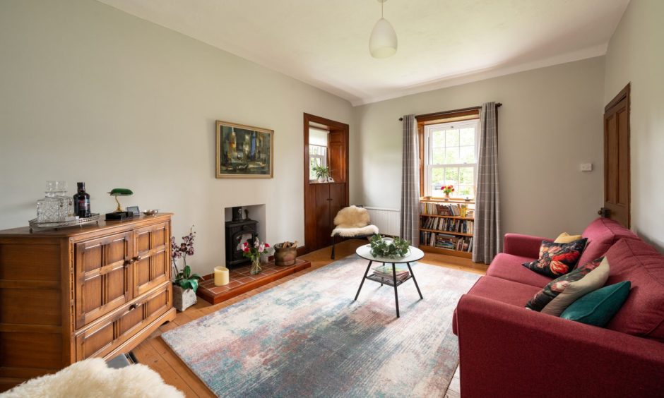 1 Arthurstone Gardens comes with a cottage, the living room of which has a wood-burning stove. 