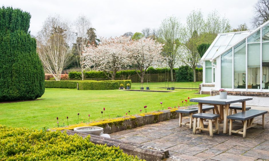 a patio and a section of the gardens at 1 Arthurstone Gardens