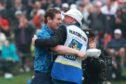 Bob MacIntyre celebrates with his caddie and father Dougie MacIntyre.