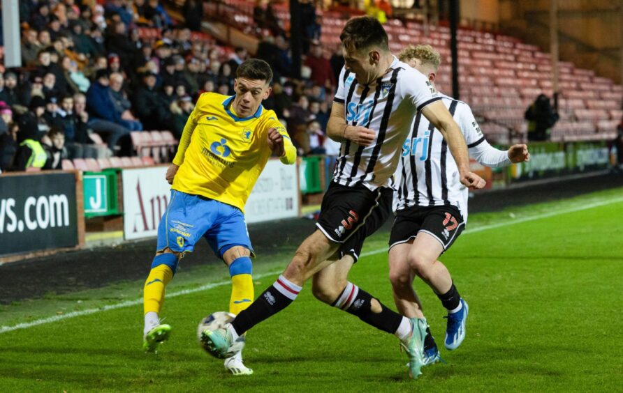 Josh Edwards in action for Dunfermline Athletic F.C. as he blocks a cross from Raith Rovers winger Josh Mullin.