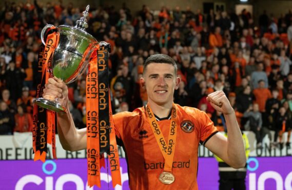 Dundee United defender Ross Graham with the Championship trophy. Image: SNS