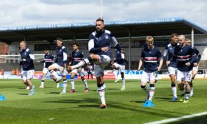 Clark Robertson warms up ahead of his first Dundee appearance.