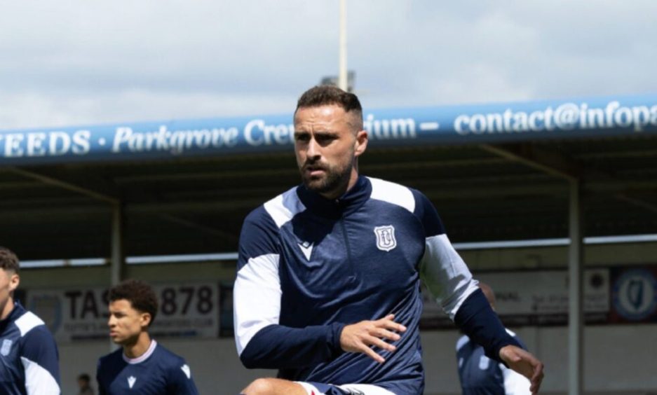 Clark Robertson warms up ahead of his first Dundee appearance.