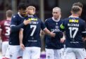 Scott Tiffoney takes the congratulations from his Dundee team-mates at Arbroath. Image: SNS
