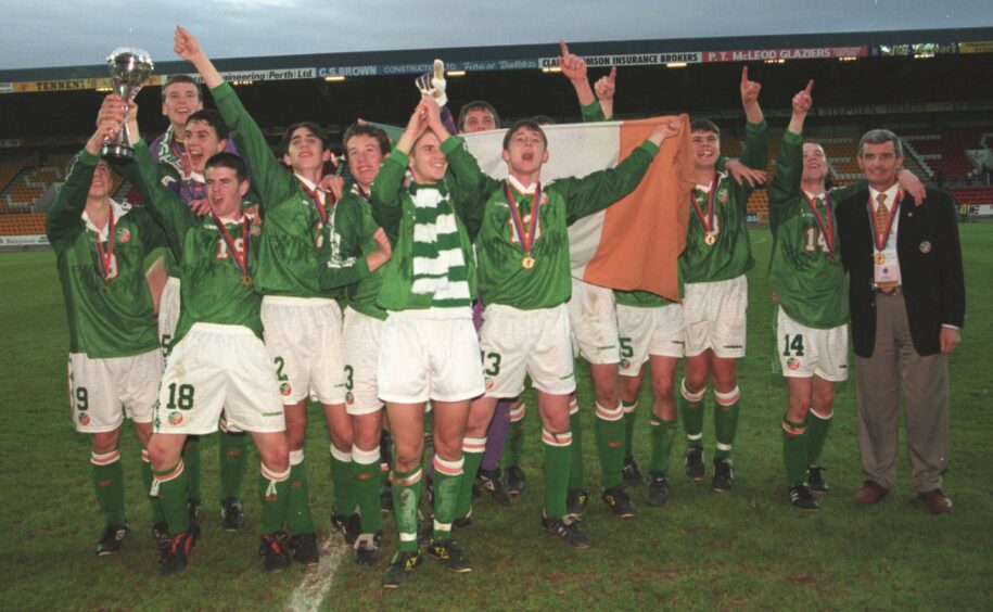 Liam Miller of Ireland (left) holds up the cup in celebration