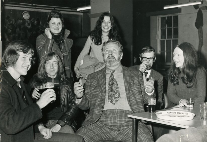 Rector Peter Ustinov enjoys a drink with students in 1972.