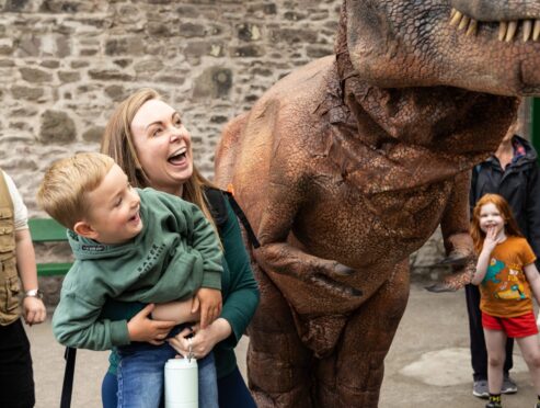 Mum Amy Manson and son Leithem meet T-Rex. Image: Ethan Williams