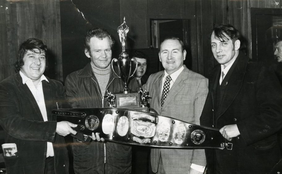 George Kidd showing off his title belt in the pub in 1976. 