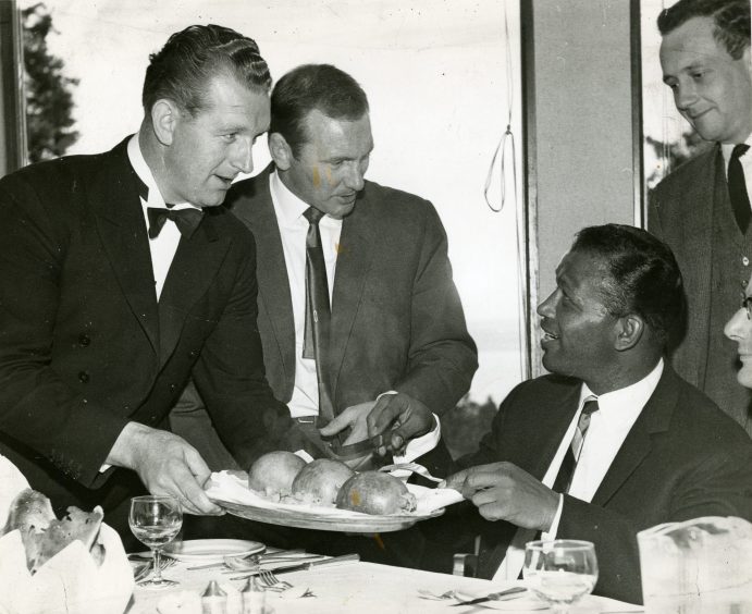 Sugar Ray Robinson is served haggis at the Invercarse Hotel. 