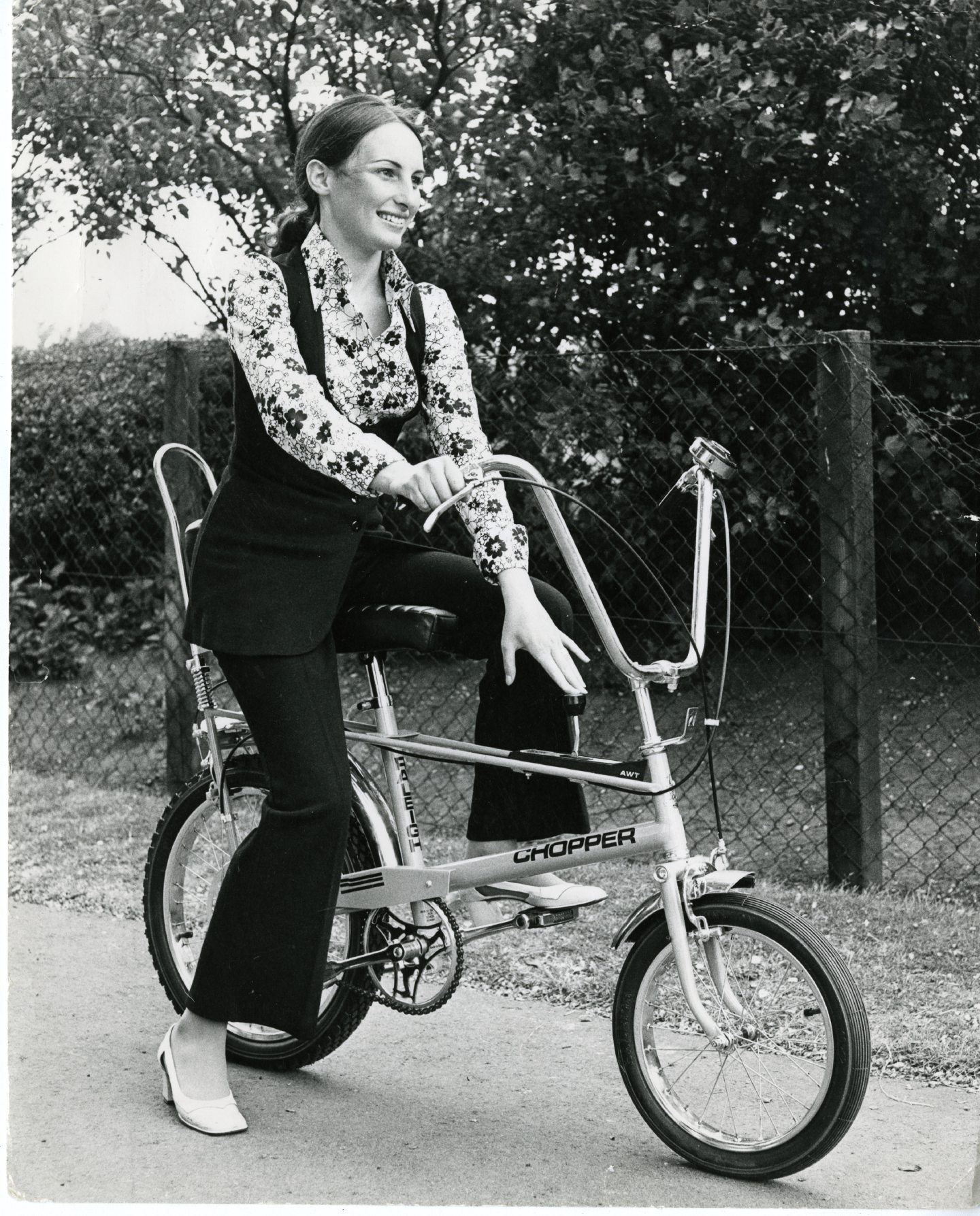 A woman sitting on a Raleigh Chopper, the bike of the 1970s.