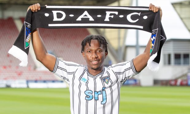 New signing Kieran Ngwenya holds up a Dunfermline scarf.