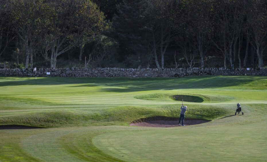 Archie wanted to move to Fife after a visit to Balcomie Links, pictured above as a man takes a shot from a bunker. 