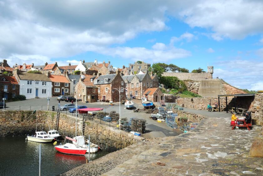 Crail Harbour, with boats in the foreground and homes in the background