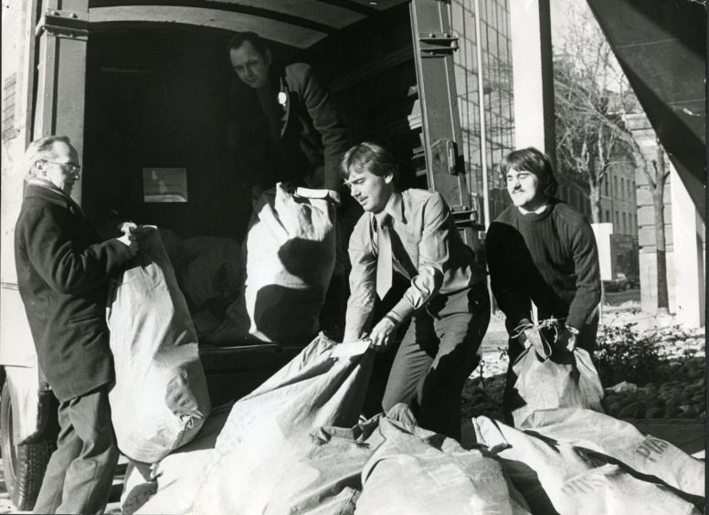 Revaluation notices being loaded by the sackful by three men on to a van at Tayside House in February 1978.