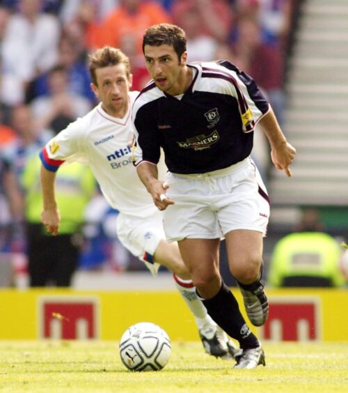 Dundee's Zurab Khizanishvili chased down by Neil McCann of Rangers. Image: SNS